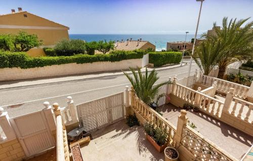 a view of a street with a fence and the ocean at 2 Bedroom Awesome Home In Elche in Elche