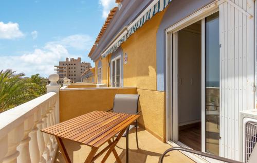 a balcony with a wooden table and a table at 2 Bedroom Awesome Home In Elche in Elche