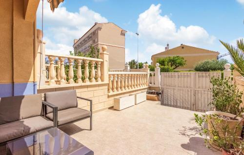 a patio with a couch and a fence at 2 Bedroom Awesome Home In Elche in Elche