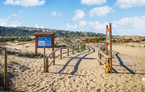 a sign in the sand at the beach at 2 Bedroom Awesome Home In Elche in Elche