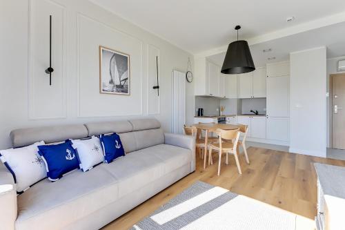 a living room with a couch and a table at GRANO FLATS - Sobieszewo - Baltic Porto in Gdańsk