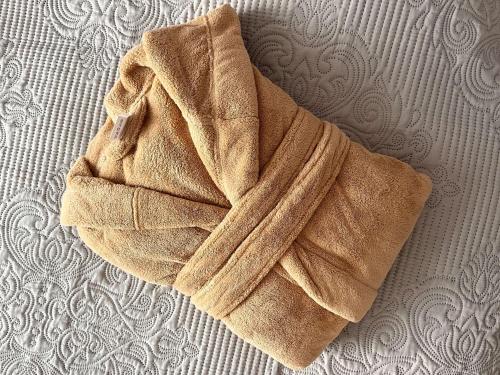 a towel laying on top of a bed at Apartment am Schloss-Park Wiesbaden Biebrich am Rhein in Wiesbaden