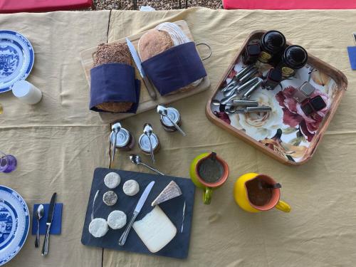 een tafel met een dienblad met eten en andere artikelen erop bij Mas Chamsomat in Robion en Luberon