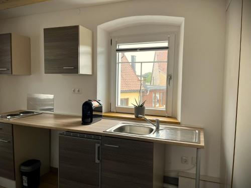 a kitchen with a sink and a window at Gasthaus Weißes Ross in Burghaslach