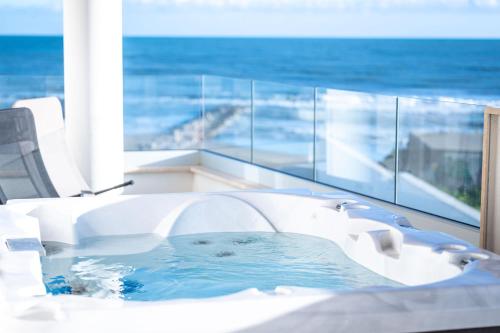 a bath tub with a view of the ocean at I Bordin Home in Nettuno