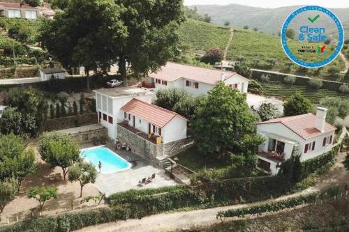 an aerial view of a house with a swimming pool at Quinta da Pousada Casa de Campo in Santa Marta de Penaguião