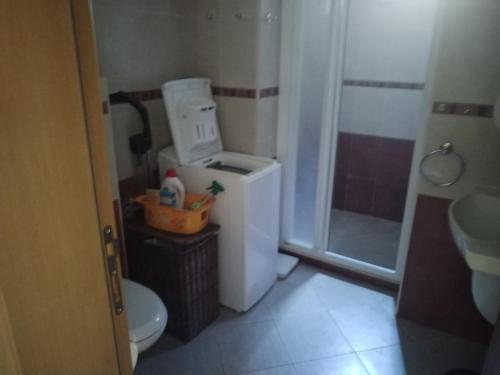 a small bathroom with a toilet and a sink at Санта Марина-Сладка къща in Sozopol