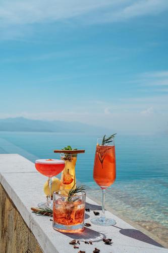 a group of drinks sitting on a ledge near the water at Elevate Bali in Munduk