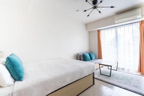 a bedroom with a large bed and a window at Best Residence Kujo in Osaka