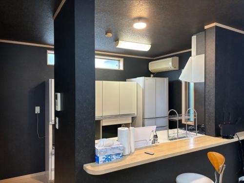 a kitchen with a counter with white appliances on it at Hamachidesu - Vacation STAY 15817 in Akiruno