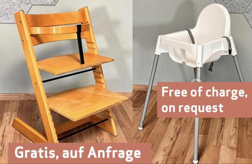 a chair sitting next to a wall with the words deficits artnance and fire at Apartment am Schloss-Park Wiesbaden Biebrich am Rhein in Wiesbaden