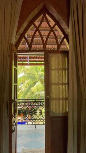 an open door with a view of a patio at The Postcard Saligao in Calangute