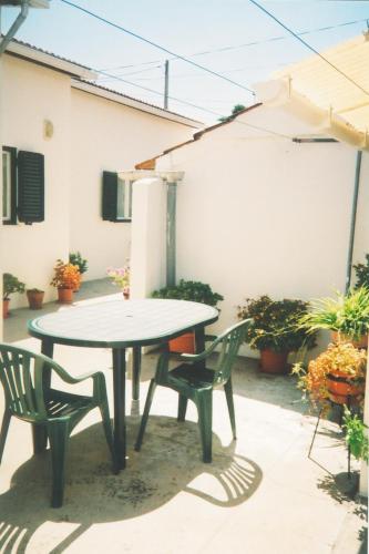 a table and two chairs on a patio at Casa Baptista I in Marinha Grande
