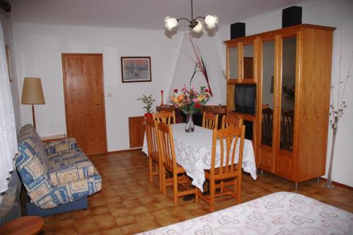 a living room with a table and chairs and a television at Casa Baptista I in Marinha Grande