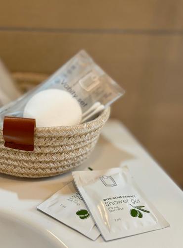 a basket of soap and a bar of toothpaste on a table at Home To Salerno B&B in Salerno