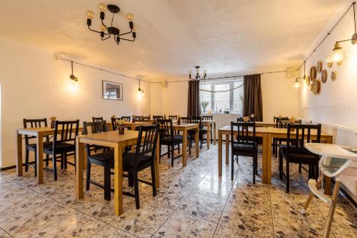 a dining room with wooden tables and chairs at Gremi Hotel in Dragobrat