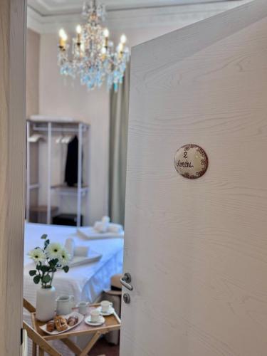a door to a room with a bed and a chandelier at Home To Salerno B&B in Salerno