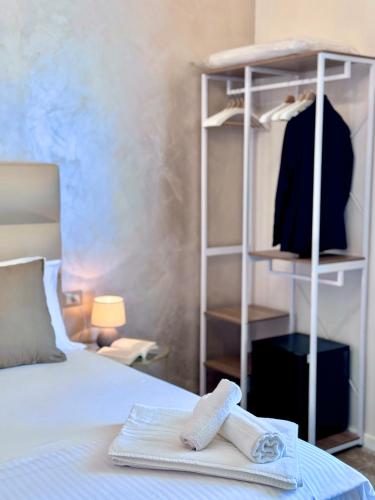 a pair of towels on a bed in a bedroom at Home To Salerno B&B in Salerno