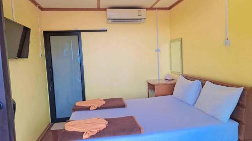 a bedroom with a large bed with blue sheets at Phi Phi Sand Sea View Resort in Phi Phi Don