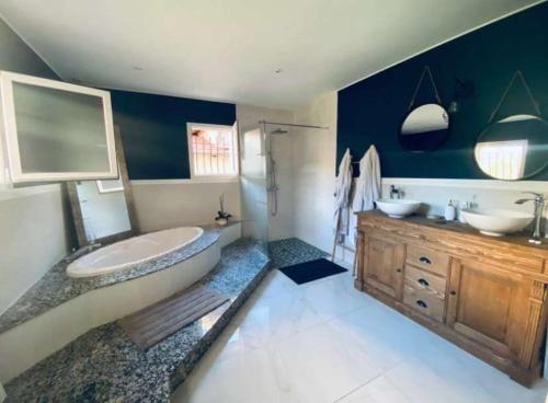 a bathroom with a tub and a sink and a shower at Magnifique, villa avec Piscine in Dax