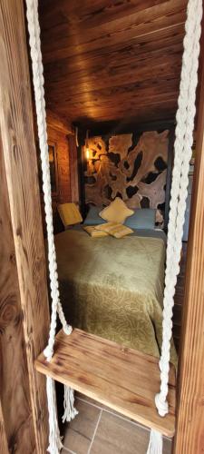 a bed in a wooden room with a swing at Ma Cabane in Collioure