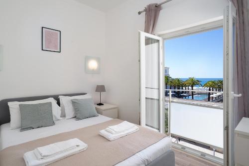 a bedroom with a bed with a view of the ocean at Vistamar Apartments in Portimão