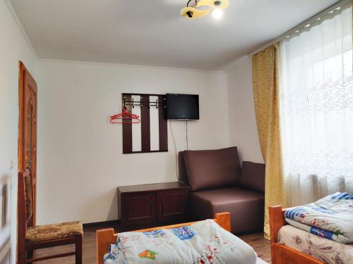 a living room with a couch and a chair at "У Яслигана" in Pilipets