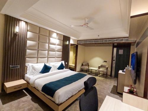 a bedroom with a large bed in a room at AR Plaza in Chandīgarh