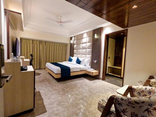 a hotel room with a bed and a couch at AR Plaza in Chandīgarh