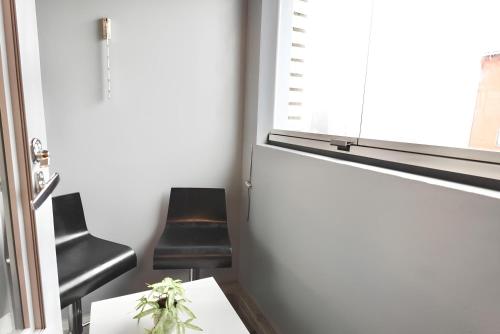 a room with two chairs and a table and a window at Flamingo Studio, Free Parking, 2 Min to Airport and Spa in Vantaa