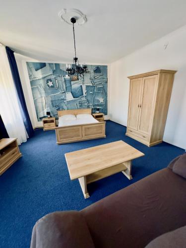 a large room with two beds and a table at Hotel Růžek in Hranice