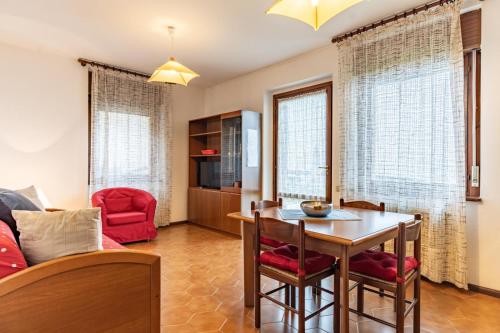a kitchen and living room with a table and chairs at Residenza Panarotta - Vetriolo(1500m) in Levico Terme