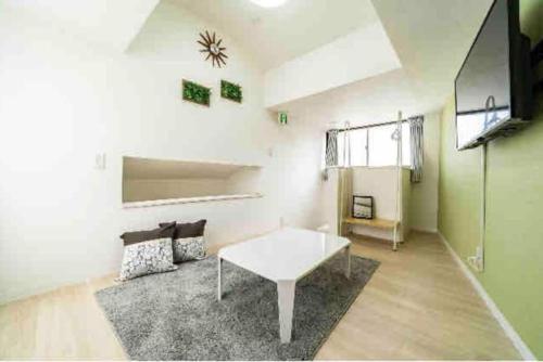 a living room with a white table and a couch at 55, Kameido-Suijin, Entire house for rent, 亀戸水神 in Tokyo