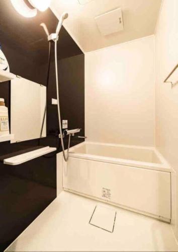 a bathroom with a sink and a bath tub at 55, Kameido-Suijin, Entire house for rent, 亀戸水神 in Tokyo
