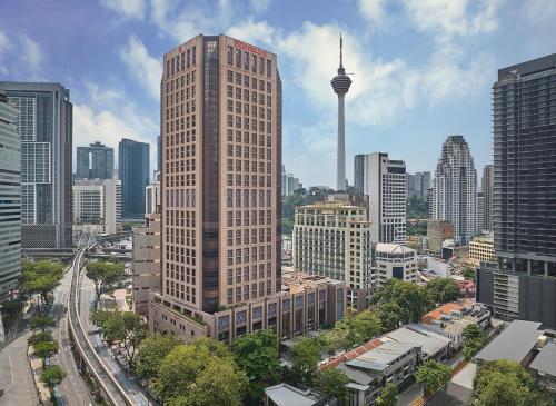 a tall building in the middle of a city at Sheraton Imperial Kuala Lumpur Hotel in Kuala Lumpur