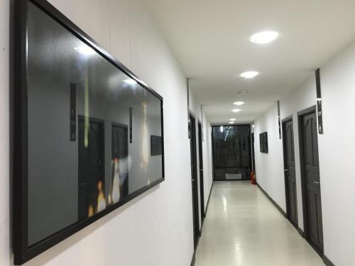 a hallway of a hospital with paintings on the walls at At Sakon Hotel in Sakon Nakhon