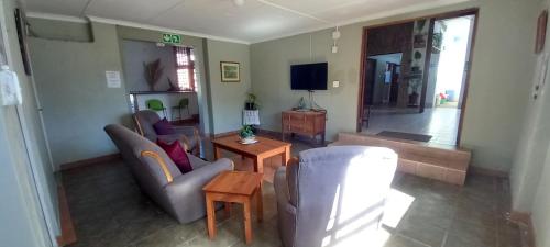 a living room with two couches and a tv at Oceanic Flashpackers accommodation in East London