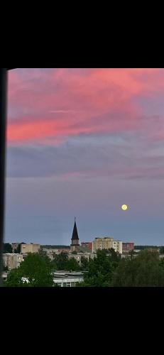 a view of a city skyline with a sunset at GIN Apartment No 82 SELF CHECK-IN in Mažeikiai