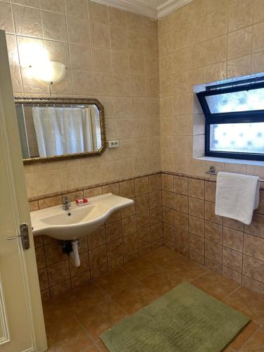 a bathroom with a sink and a mirror and a window at Beautiful & Cozy Newly remodeled 2 Bedroom in Amman