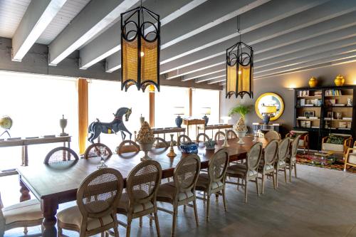 a dining room with a long table and chairs at Maison La Herrería B&B in Villanueva de Henares