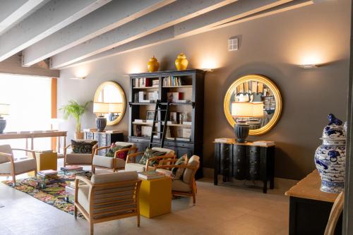 a living room filled with furniture and a mirror at Maison La Herrería B&B in Villanueva de Henares