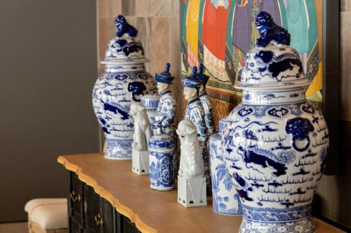 a group of blue and white vases on a table at Maison La Herrería B&B in Villanueva de Henares