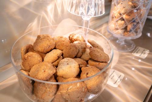 a glass bowl full of cookies on a table at Il Portico - 1711 Luxury Guest House in Arlate