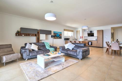a living room with two couches and a table at Stunning 3-Bedroom Seaview Retreat in Fort Cambridge in Sliema