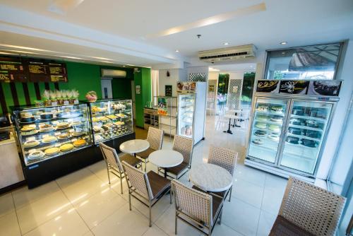 a restaurant with tables and chairs and a bakery at L'Fisher Hotel Bacolod in Bacolod