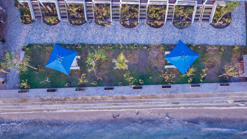 two blue umbrellas on the side of a building at Moyo Island Resort in Moyo Island