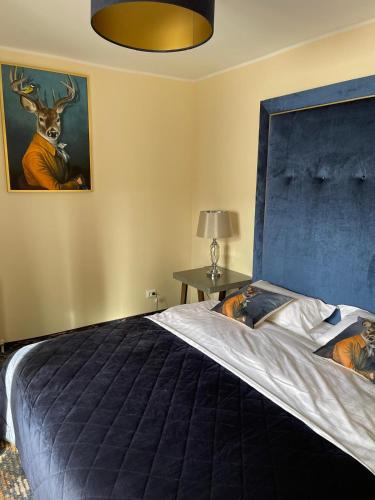 a bedroom with a large bed with a deer painting on the wall at Zwei Hirsche in Seefeld in Tirol
