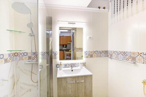 a bathroom with a sink and a shower at Alohe Puertorico View in Puerto Rico de Gran Canaria