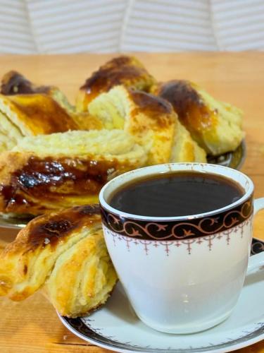 a plate with a cup of coffee and some food at LUCY B&B in Garni
