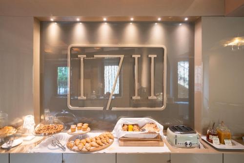 a kitchen with a counter with food and a mirror at Il Pozzo - 1711 Luxury Guest House in Arlate